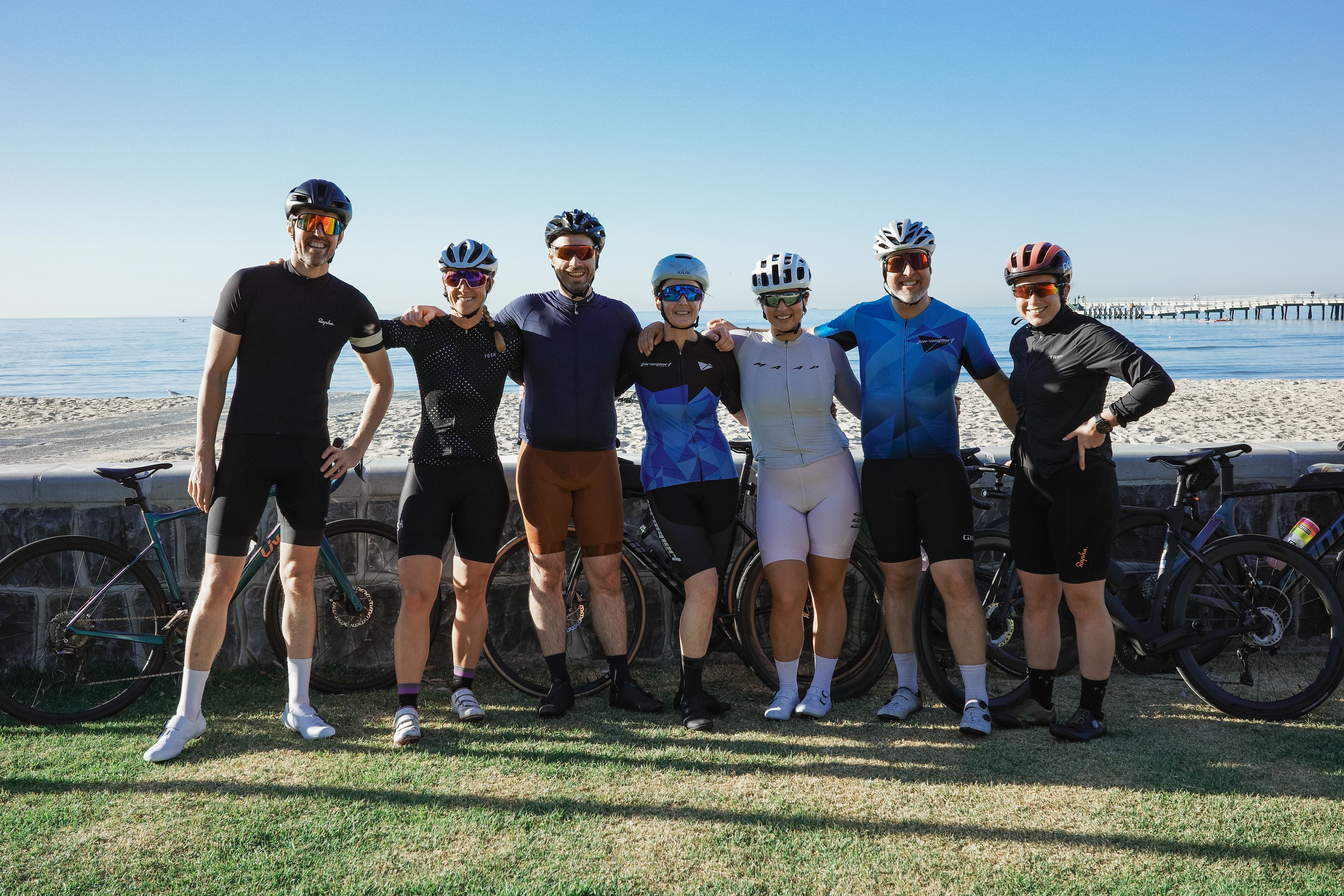 Group of cyclists on a beachside path